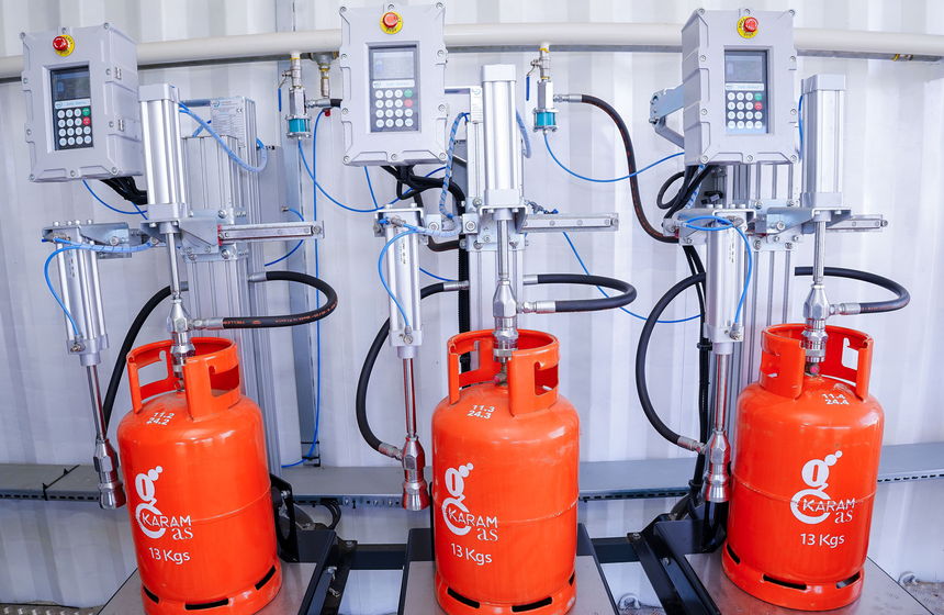 Karam Gas 13 kg cylinders on the filling carousel