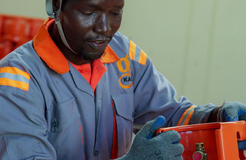 A Karam Gas technician checking a cylinder valve