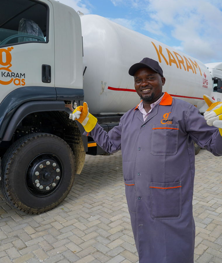 A Karam Gas driver beside an LPG tanker